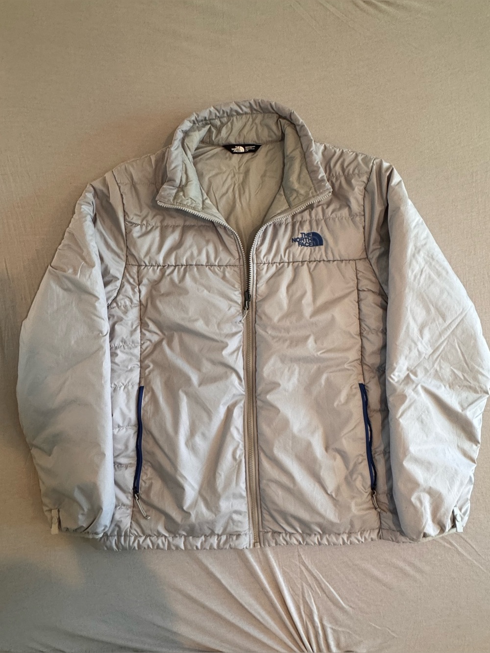 The North Face Light Gray Men's Puffer Jacket with Blue Accents